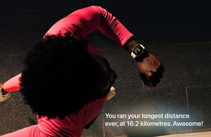 Photo of a man using his Apple Watch to track his run