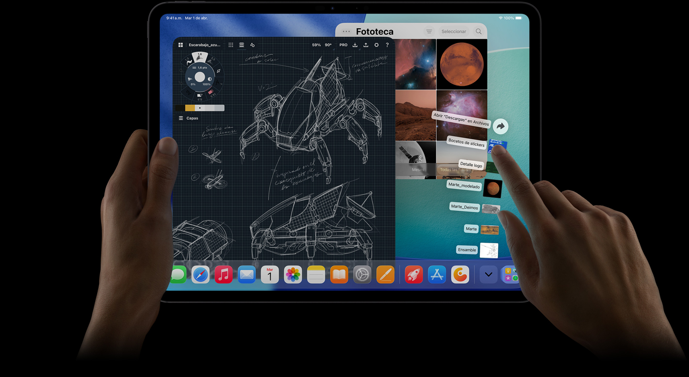 iPad Pro, parte frontal, posición horizontal, una mano derecha hace un gesto sobre archivos de la carpeta de descargas ubicados en forma de abanico, la pantalla muestra la interfaz de iPadOS 26 con varias apps abiertas incluida una app de edición de fotos que muestra los planos detallados de un robot y anotaciones escritas a mano, varias etapas del diseño y la fototeca