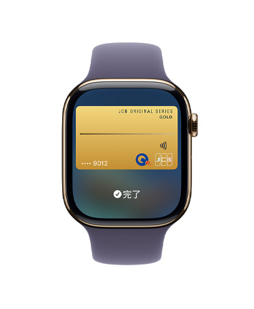 ゴールドチタニウムケースのApple Watch Series 11。Apple Payの画面が表示されている。外観の右側にDigital Crownが見えている。パープルフォグのスポーツバンドが付いている