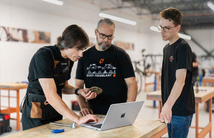 Nicolas Paquin, chuyên viên tập huấn của Bicycles Quilicot, sử dụng MacBook Pro để truy cập tài liệu cho chương trình chứng chỉ thợ cơ khí xe đạp miễn phí của công ty.